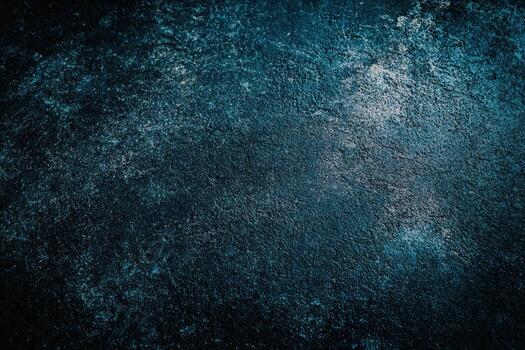 Dark textured surface with a blue hue in a dim light photo