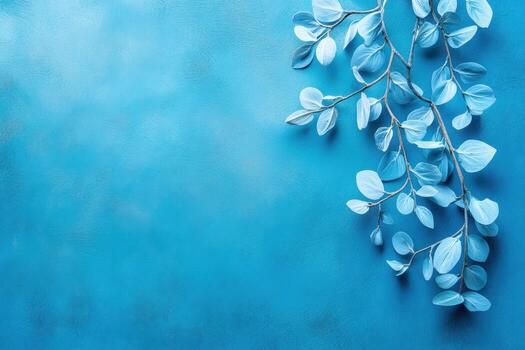 Blue background with light green leaves creating a calming scene photo