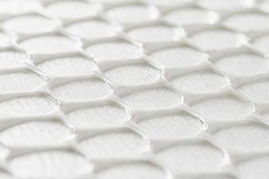 Textured surface showing honeycomb pattern in white color photo