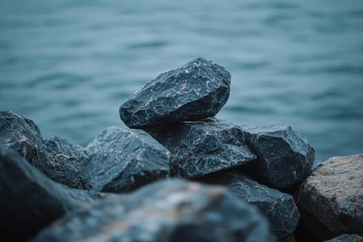 Rocks stacked by the water in a tranquil setting photo