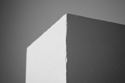 Clean white corner of a wall in a simple indoor space photo