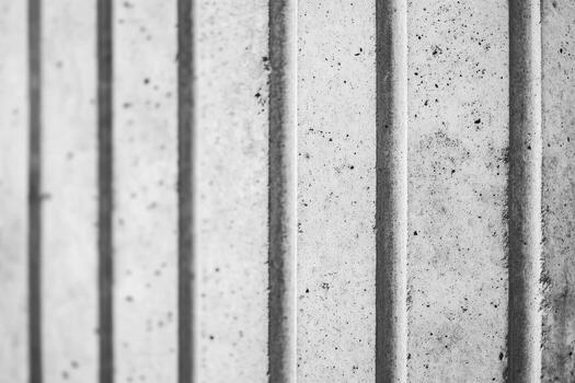 Textured concrete wall features vertical lines and patterns photo