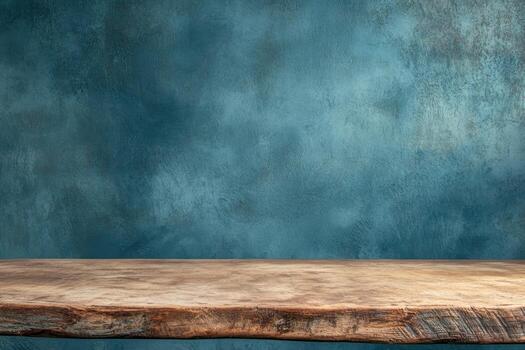 Wooden table with textured blue background for display photo