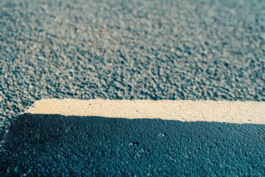 Dark asphalt with white line in natural light during daytime photo