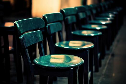 Rows of wooden chairs in a quiet indoor setting photo