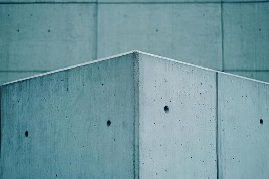 Concrete corner structure with clean lines and blue tint photo
