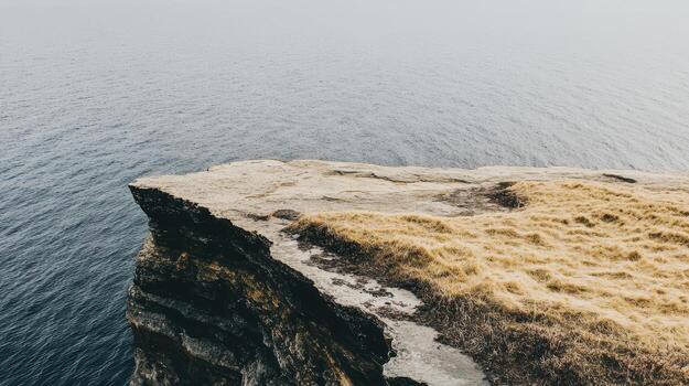 Scenic cliff edge overlooking calm ocean water photo
