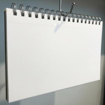 Blank spiral bound notebook page hanging by a metal clip isolated on white background photo