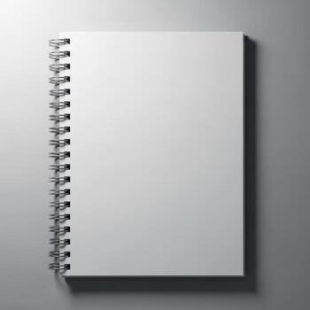 A blank white spiral bound notebook with a metal coil binding is presented isolated on white background photo