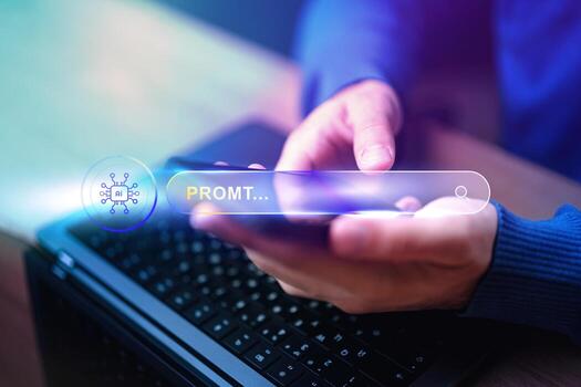 Hands typing on a smartphone while searching for information on a laptop in a modern workspace photo