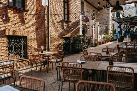 Outdoor dining area with string lights and rustic architecture in a cozy courtyard on a sunny day photo