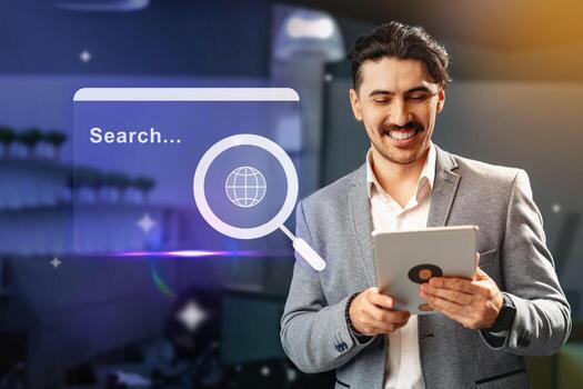 Man using tablet for online research in a modern workspace with digital interface displayed in the background during daylight photo