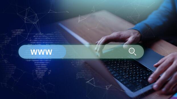 Hands typing on laptop keyboard while searching the web with digital graphics in a modern workspace photo