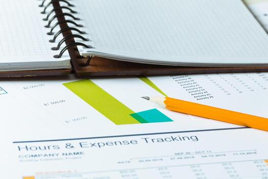 Expense tracking and planning in a neat notebook on a desk with financial reports photo