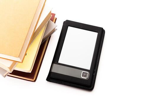 Digital tablet placed next to a stack of colorful books on a white background photo