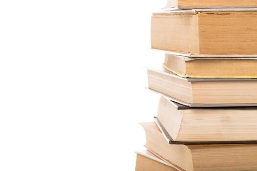 Stack of old books resting on each other in a bright, minimalist setting photo