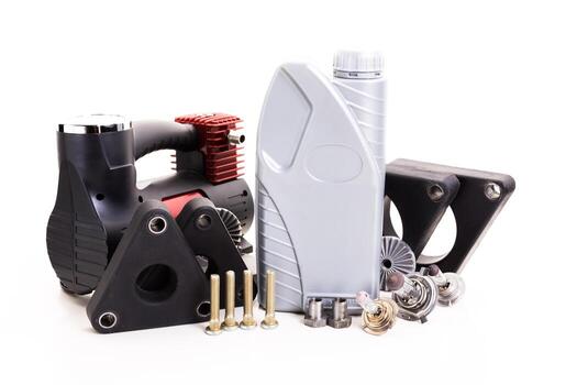 Collection of automotive parts and tools arranged on a white surface in a workshop setting photo