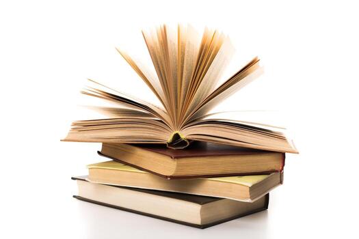 Open book resting on stacked books in a bright setting inviting reading and learning photo