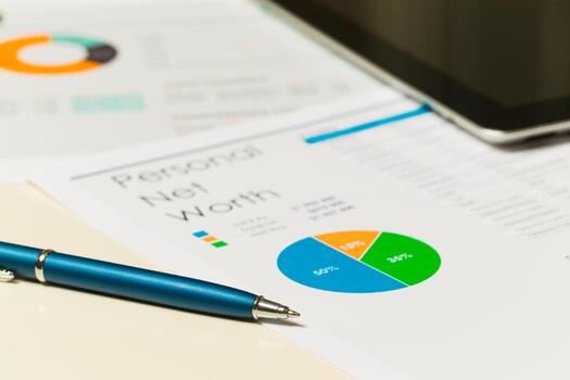 Financial analysis report showing personal net worth with charts and graphs on a desk photo