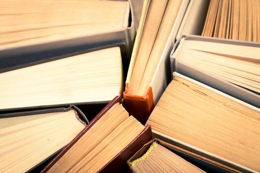 Stacked books with varying colors and textures arranged in a circular pattern photo