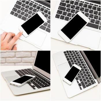 Hand interacting with smartphone on laptop keyboard in a minimal workspace setup photo