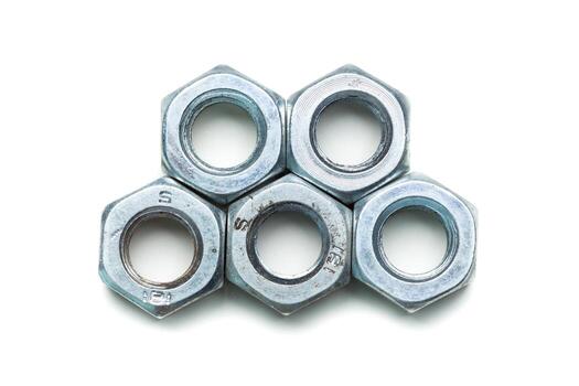 Metal nuts arranged in a stack, showcasing their hexagonal shape and shiny surface photo