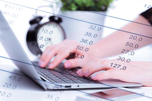 Data analysis with laptop and clock during work hours in an office setting photo