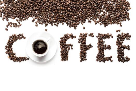 Freshly brewed coffee with beans arranged creatively on a white background photo