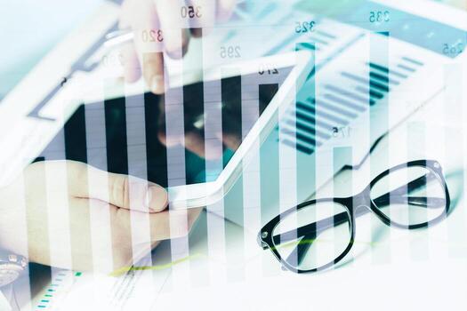 Business analysis using tablet with graphs and charts in the workspace photo