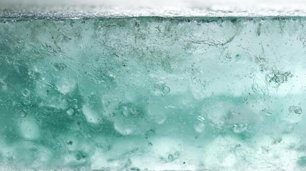 Clear ice block with bubbles frozen inside during winter season photo