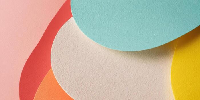 Colorful layered paper shapes on a light background photo