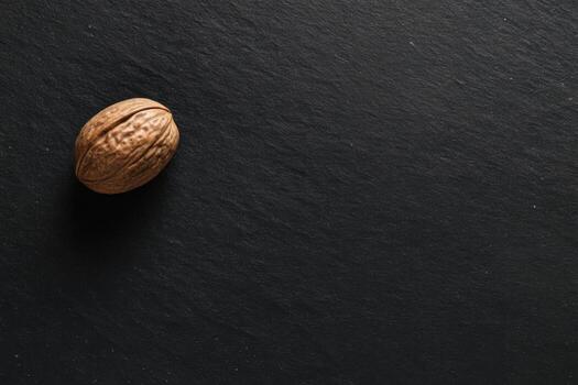 Walnut resting on a dark stone surface photo