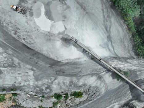 Granite and limestone crushing plant with excavators processing raw stone into construction aggregates for concrete and infrastructure development. Stone mill factory. photo