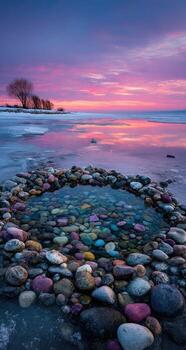 A circle of rocks on the shore of a lake photo