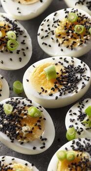 A close up of deviled eggs with sesame seeds photo