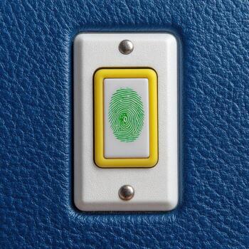A fingerprint button on a blue leather surface photo