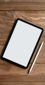 Tablet with blank screen and pen on wooden background photo