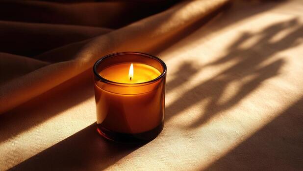 A candle is sitting on a table with a shadow photo
