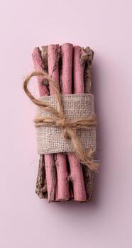 A bundle of pink sticks wrapped in twine photo
