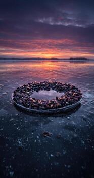 A circular stone circle is sitting on the water photo