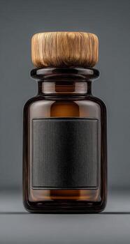 A glass bottle with a wooden lid on a gray background photo