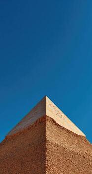 A pyramid with a blue sky in the background photo