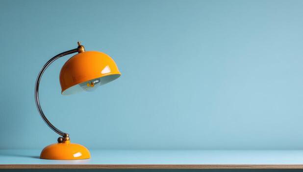 An orange lamp on a table with a blue background photo
