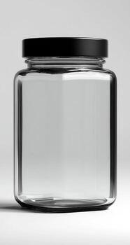 A clear jar with a black lid on a white surface photo