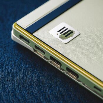 A close up of a white laptop with a blue and yellow stripe photo