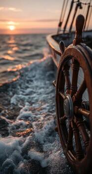 A wooden wheel on a boat at sunset photo