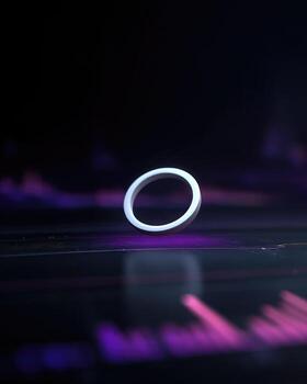 A ring is sitting on a table with a purple background photo