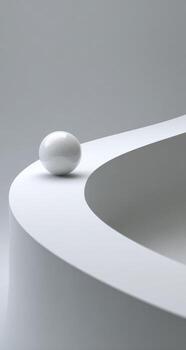 A white ball sits on top of a curved surface photo
