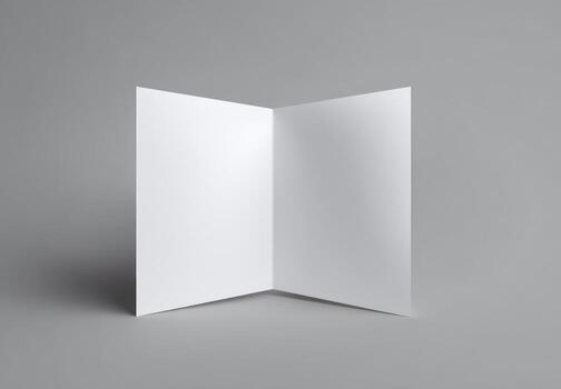 Blank white paper folded open on a gray background photo