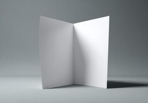 A blank white folded paper on a gray background photo